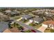 Aerial view showcasing a residential neighborhood with well-maintained homes, manicured lawns, and tree-lined streets at 447 Simpson St, The Villages, FL 32162