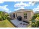 Exterior of home showing the screened lanai, patio, and well-maintained lawn at 447 Simpson St, The Villages, FL 32162