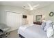 Bright bedroom featuring a comfortable bed, ceiling fan, closet, and tasteful decor at 447 Simpson St, The Villages, FL 32162