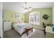 Inviting bedroom with vaulted ceilings, ceiling fan, and large shuttered window at 447 Simpson St, The Villages, FL 32162