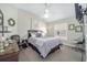 Cozy bedroom features soft, neutral decor, a ceiling fan, and a bright window with plantation shutters at 447 Simpson St, The Villages, FL 32162