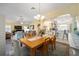 Open-concept dining area with wood table, pendant lighting, and view of the living room at 447 Simpson St, The Villages, FL 32162
