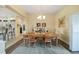 Formal dining area with wood table, chandelier lighting, and stylish decor at 447 Simpson St, The Villages, FL 32162
