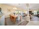 Open-concept dining room with stylish chairs and a view of the backyard at 447 Simpson St, The Villages, FL 32162