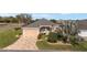 Charming single-story home with a well-manicured lawn, a two-car garage, and mature landscaping at 447 Simpson St, The Villages, FL 32162