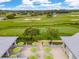 Picturesque golf course view from the veranda with green umbrellas, trees, and a beautiful landscape at 447 Simpson St, The Villages, FL 32162