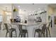 Kitchen featuring stone counters, breakfast bar seating, and modern appliances at 447 Simpson St, The Villages, FL 32162