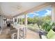 Spacious enclosed lanai featuring dining and seating areas with views of the lush backyard at 447 Simpson St, The Villages, FL 32162