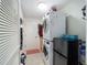 Efficient laundry area with stacked washer/dryer, additional storage, and convenient access to an exterior door at 447 Simpson St, The Villages, FL 32162