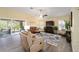 Cozy living room with wood floors, vaulted ceiling, a ceiling fan, and comfortable seating at 447 Simpson St, The Villages, FL 32162
