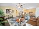 Bright living room featuring hardwood floors, a ceiling fan, and comfortable furniture at 447 Simpson St, The Villages, FL 32162