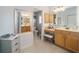 A large bathroom with a vanity, a makeup station, and a view to the water closet at 447 Simpson St, The Villages, FL 32162