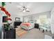 Beautiful main bedroom featuring tray ceilings, ceiling fan, and large windows with shutters at 447 Simpson St, The Villages, FL 32162
