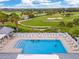 Aerial view of the community pool, golf course, and surrounding lush landscaping at 447 Simpson St, The Villages, FL 32162