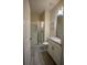 Clean bathroom featuring a glass-enclosed shower, a single sink vanity, and neutral tile floors at 4836 Romeo Cir, Kissimmee, FL 34746