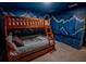 The bedroom has a bunk bed and painted closet doors with a mountain theme at 4836 Romeo Cir, Kissimmee, FL 34746