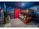 The bedroom has a bunk bed and mural of a castle, with red curtains at 4836 Romeo Cir, Kissimmee, FL 34746