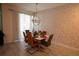 Tastefully decorated dining room features a modern chandelier and seating for six at 4836 Romeo Cir, Kissimmee, FL 34746