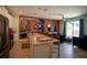 Modern kitchen with a spacious island, bar seating, and an adjacent living area with decorative murals at 4836 Romeo Cir, Kissimmee, FL 34746