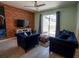 Comfortable living room features stylish furniture and a view of the screened-in pool at 4836 Romeo Cir, Kissimmee, FL 34746