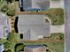 An aerial view of the home's roof and surrounding yard with manicured landscaping and inviting curb appeal at 485 Pixie Ln, The Villages, FL 32162