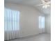 Bright bedroom featuring light-colored floors and windows with sheer curtains at 485 Pixie Ln, The Villages, FL 32162