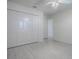 Bright bedroom features neutral walls, ceiling fan and a large closet at 485 Pixie Ln, The Villages, FL 32162