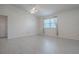Bright bedroom featuring white walls, light floors, and large windows at 485 Pixie Ln, The Villages, FL 32162