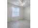 Neutral bedroom with bright walls, ceiling fan and window with pleated blinds at 485 Pixie Ln, The Villages, FL 32162
