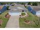 Charming single-story home featuring a well-manicured lawn, inviting curb appeal, and an attached two-car garage at 485 Pixie Ln, The Villages, FL 32162