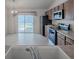 Bright kitchen features stainless steel appliances and sliding glass doors to the lanai at 485 Pixie Ln, The Villages, FL 32162