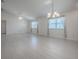 Spacious and bright living room with white walls, fan, and modern flooring at 485 Pixie Ln, The Villages, FL 32162