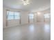 Open-concept living room with white walls, large windows, and plenty of natural light at 485 Pixie Ln, The Villages, FL 32162