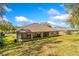 Lush backyard with a covered patio and mature trees, offering privacy and shade at 519 Hearthglen Blvd, Winter Garden, FL 34787