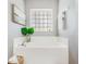 A bathroom with a soaking tub and tile surround at 519 Hearthglen Blvd, Winter Garden, FL 34787