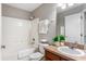 Bathroom featuring a shower-tub combo, modern vanity with sink, and decorative accents at 519 Hearthglen Blvd, Winter Garden, FL 34787