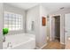 Bathroom featuring a soaking tub with privacy window at 519 Hearthglen Blvd, Winter Garden, FL 34787