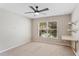 Cozy bedroom featuring a ceiling fan, a large window and a built-in desk with shelving at 519 Hearthglen Blvd, Winter Garden, FL 34787