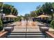 Community fountain featuring brick pavers, shaded seating areas, and lush landscaping at 519 Hearthglen Blvd, Winter Garden, FL 34787