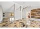Open concept living area features high ceilings, modern ceiling fan, luxury vinyl floors and rustic wood accent wall at 519 Hearthglen Blvd, Winter Garden, FL 34787