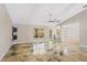 Bright open living area with neutral walls, luxury vinyl floors, modern fan, with a glimpse into the dining area at 519 Hearthglen Blvd, Winter Garden, FL 34787