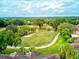 Aerial view of the golf course and community, showing lush landscaping, manicured greens, mature trees, and meandering cart paths at 54 Camino Real Blvd # 504, Howey In The Hills, FL 34737