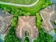 Bird's eye view of a luxurious community showcasing tile roofs, lush landscaping, and meticulously designed green spaces at 54 Camino Real Blvd # 504, Howey In The Hills, FL 34737