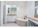 Bright bathroom featuring garden tub and vanity with granite countertops at 54 Camino Real Blvd # 504, Howey In The Hills, FL 34737
