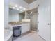 Bright bathroom featuring double vanity, granite countertop, and a glass-enclosed shower at 54 Camino Real Blvd # 504, Howey In The Hills, FL 34737