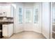 Sun-drenched breakfast nook features large windows and built-in cabinets at 54 Camino Real Blvd # 504, Howey In The Hills, FL 34737