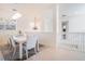 Open dining room with tile floor, modern chandelier and staircase in view at 54 Camino Real Blvd # 504, Howey In The Hills, FL 34737