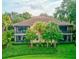 Beautiful villa with a screened balcony overlooking lush green landscaping, offering a private and serene outdoor space at 54 Camino Real Blvd # 504, Howey In The Hills, FL 34737