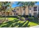 Inviting two-story townhome with lush landscaping, palm trees, and a welcoming entrance at 54 Camino Real Blvd # 504, Howey In The Hills, FL 34737