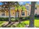 Front exterior showcasing tropical landscaping and the welcoming entryway of this beautiful home at 54 Camino Real Blvd # 504, Howey In The Hills, FL 34737